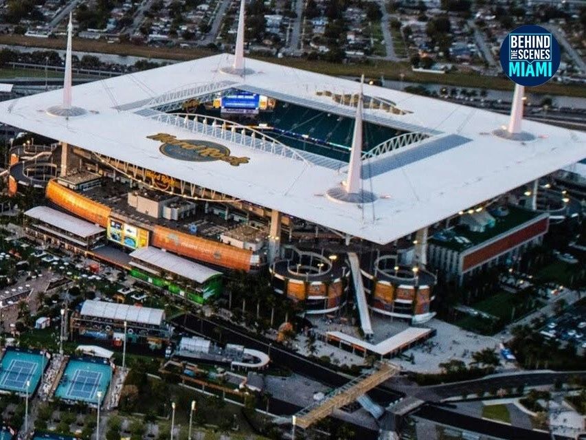 Hard Rock Stadium from above, the Miami Open courts at its feet.